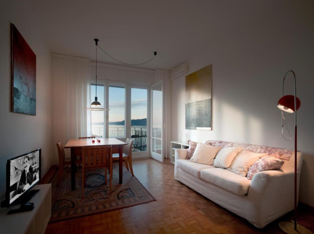 "Stylish and cozy living area with a view at Boutique Hotel Albero Nascosto, known for being one of the best hotels in Trieste near the cruise terminal, ideal for travelers seeking where to stay in the city center."