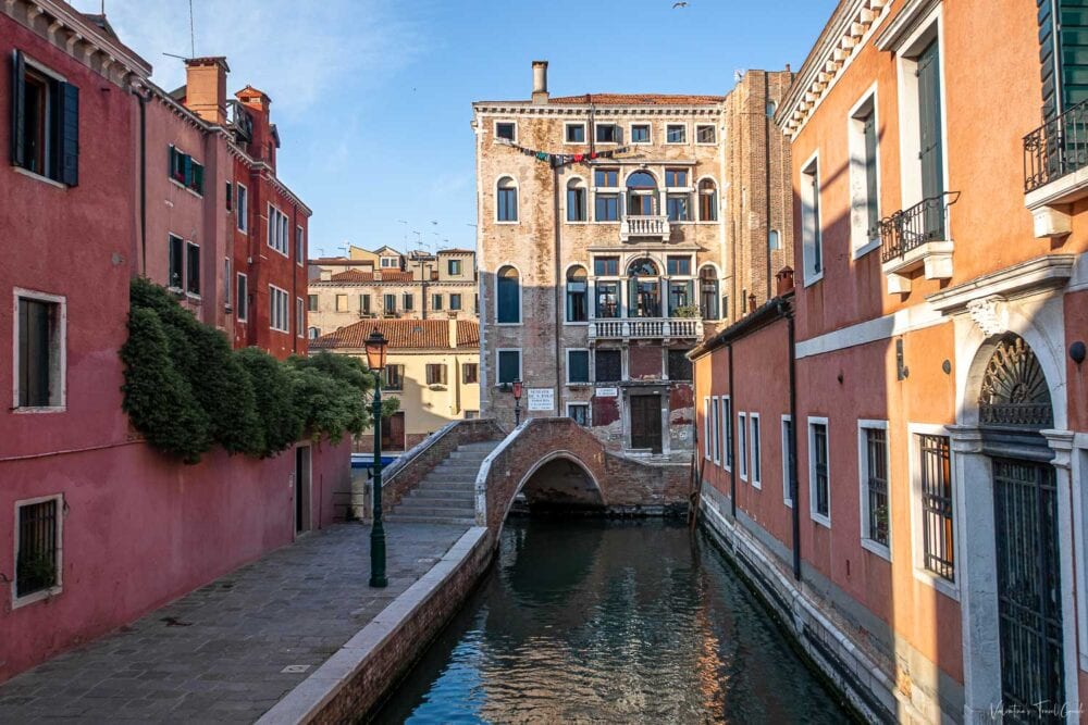 Charming canal view in Venice featuring Ponte San Boldo, surrounded by colorful historic buildings and serene water reflections; a perfect highlight for a Venice travel guide.
