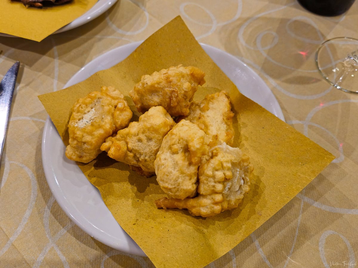 Plate of crispy fried ricotta cheese served as an appetizer, showcasing authentic Italian cuisine