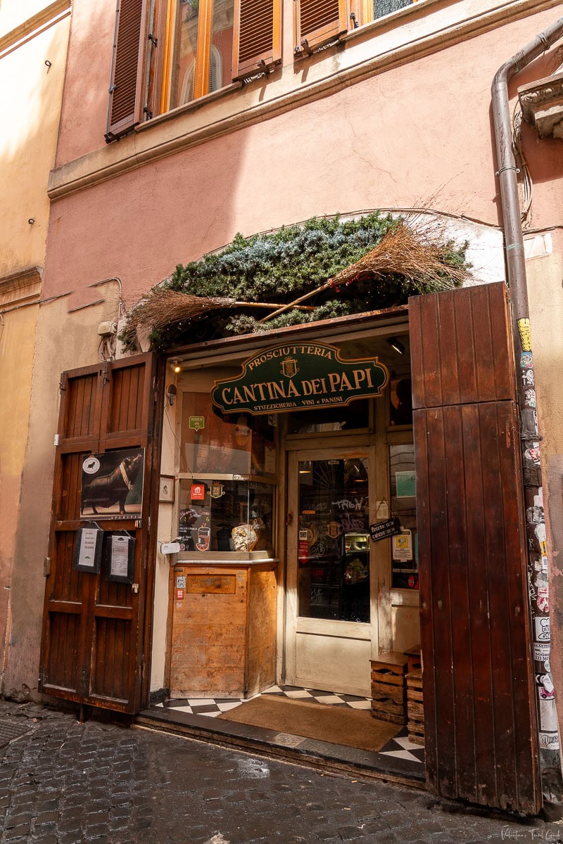 Charming entrance to Cantina dei Papi Prosciutteria in Rome, featuring rustic decor and a cozy ambiance, offering a perfect spot for where to eat in the trastevere neighborhood 