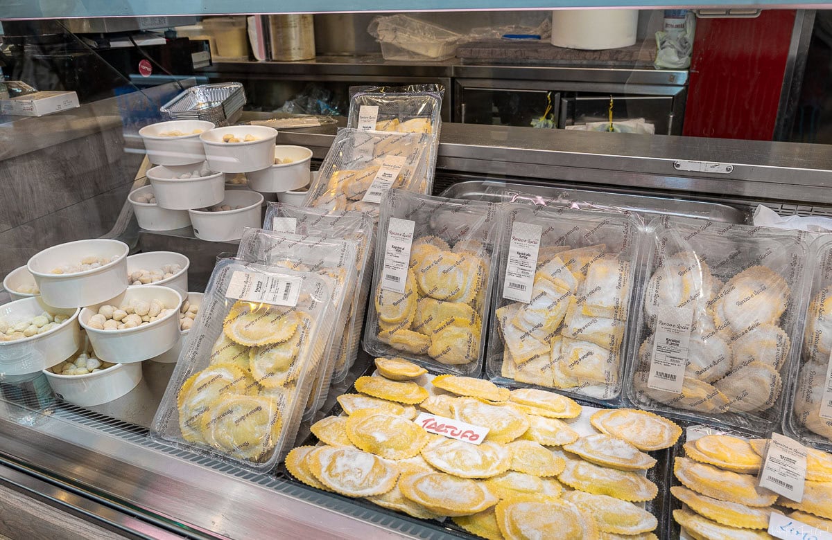 Display of fresh gnocchi and ravioli in a local market in Rome, showcasing the authentic Italian offerings you can find at some of the best restaurants